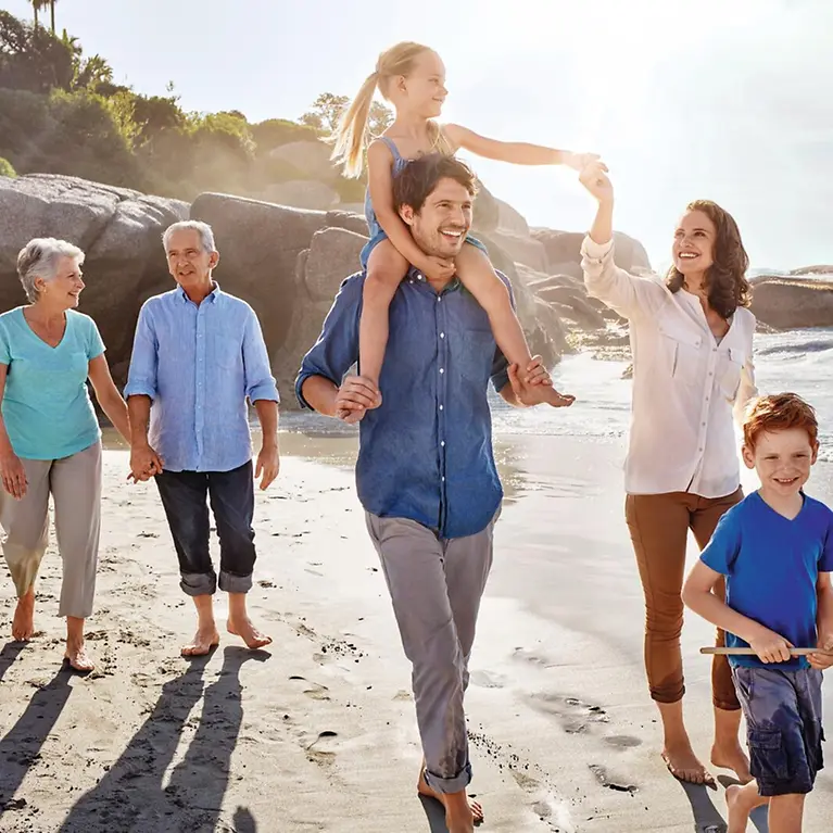 Eine Familie geht am Strand.
